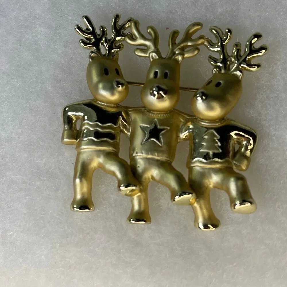 Vintage AJC three dancing deer gold tone brooch.